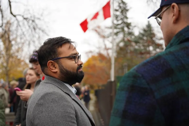Tanveer Shahnawaz speaking with Nate Erskine-Smith outdoors in winter